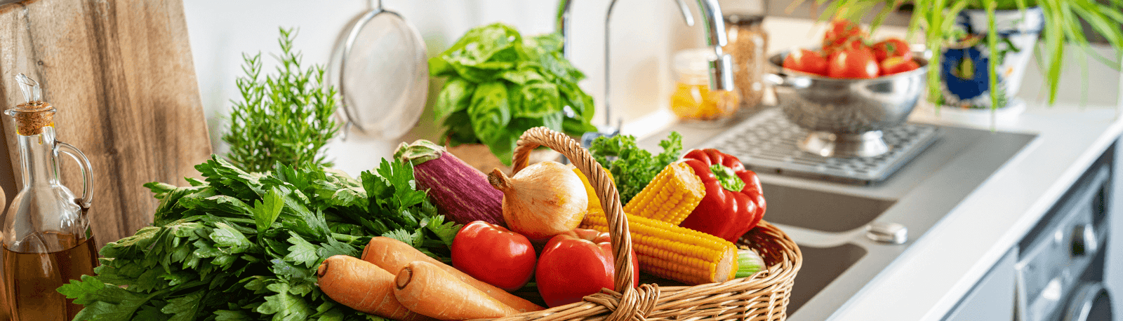 Summer superfoods in picnic basket on kitchen counter