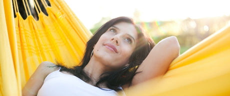 A woman laying in a hammock.