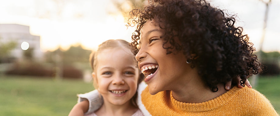Two kids laughing together.
