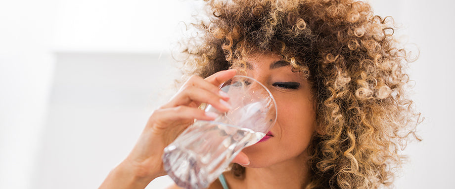A woman drinking water.