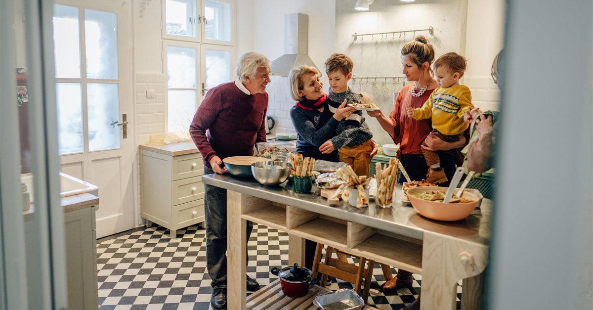 A family preparing a holiday meal in a kitchen.