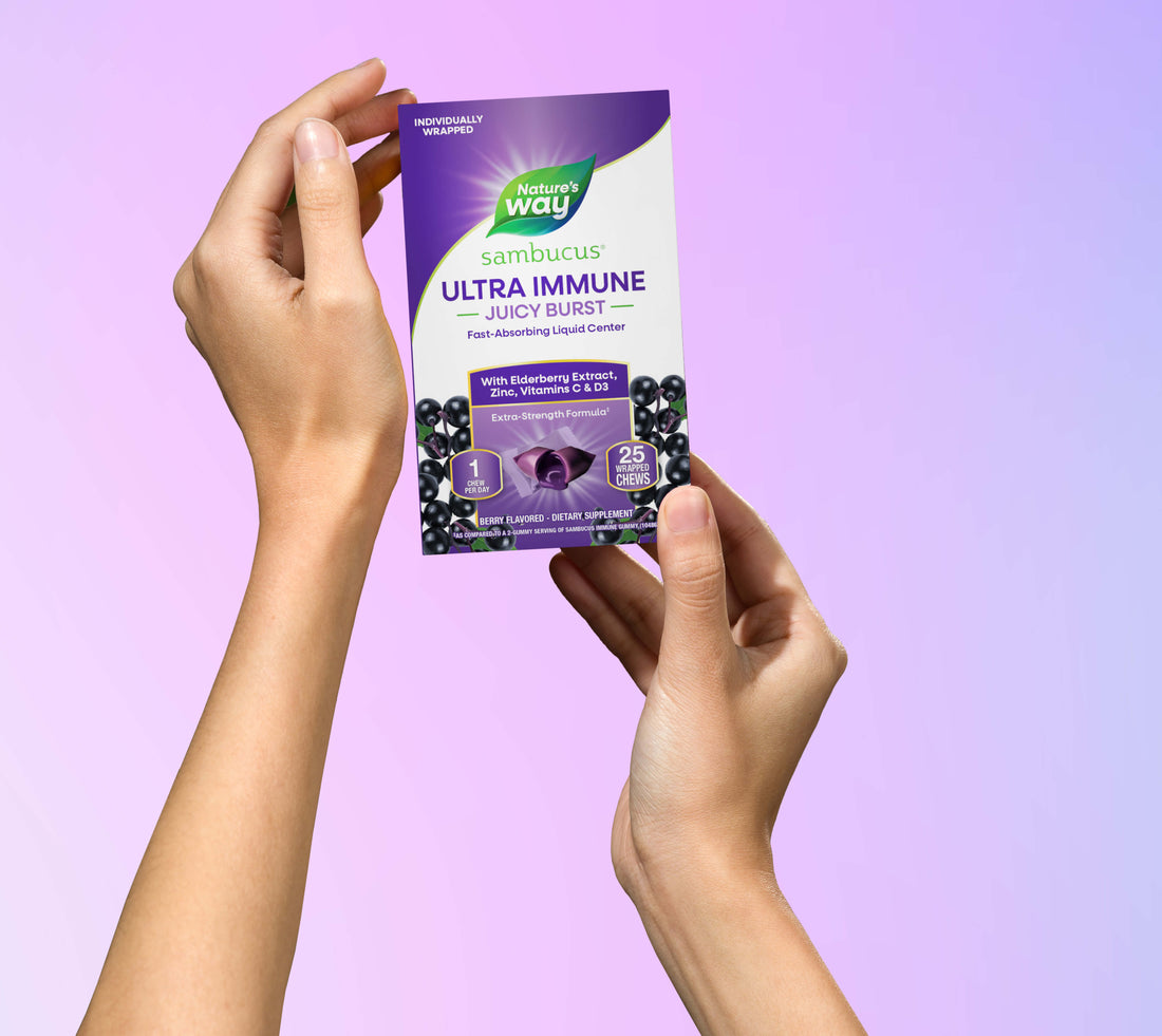 Hands holding Sambucus Ultra Immune Juicy Burst pack 