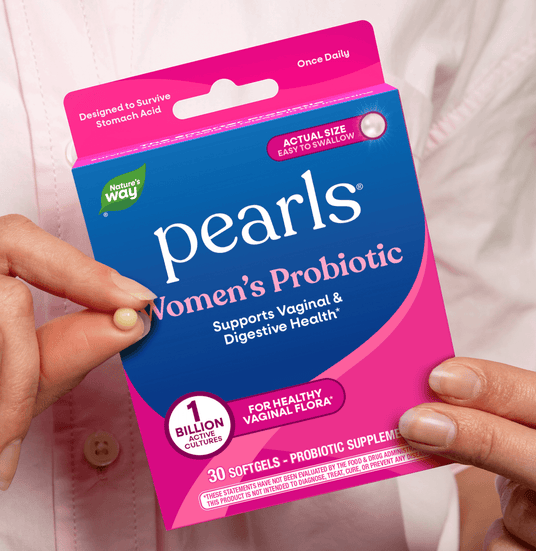 Package of Nature's Way Pearls Women's Probiotic held by a person.