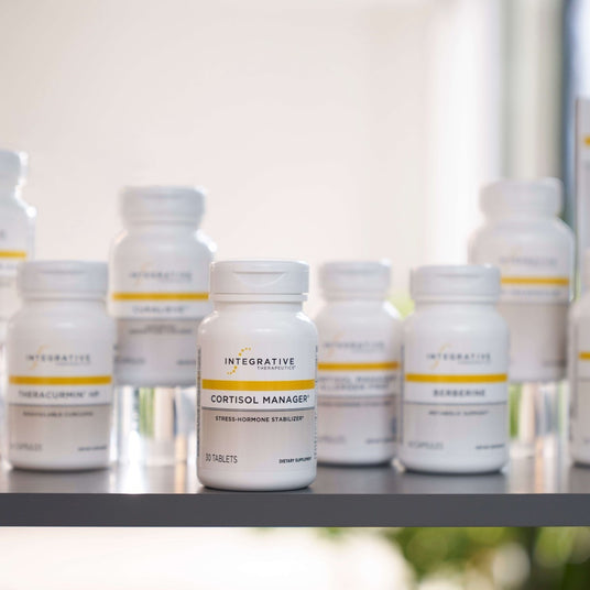 Bottles of Integrative Therapeutics Cortisol Manager on a reflective surface with a blurred background
